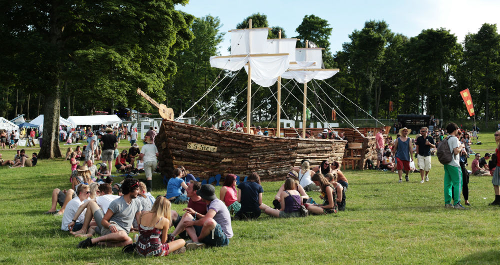 Kendall calling festival punters sitting on grass